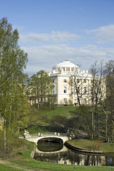 View of classical palace and bridge in picturesque park