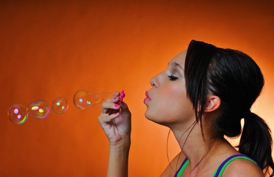 a beautiful young woman having fun with bubbles