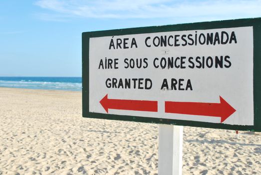 wooden sign at the beach in different languages