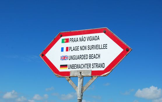 sign at the beach in different languages