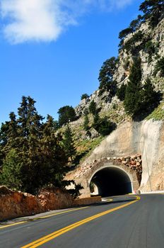 Travel photography: Mountain road passing through a tunnel in the island of 

Crete.