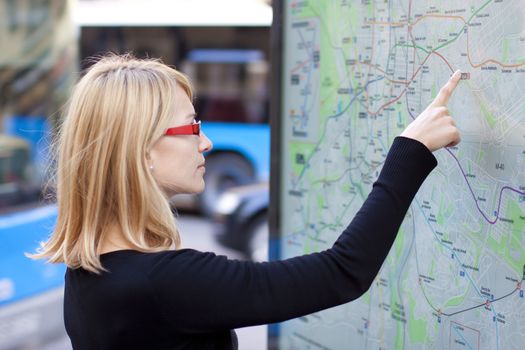 Woman orientating herself on the public transport map.