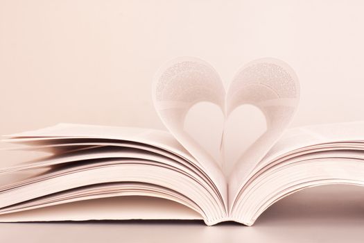 Pages of a book forming the shape of the heart.