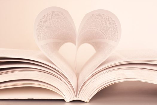Pages of a book forming the shape of the heart.