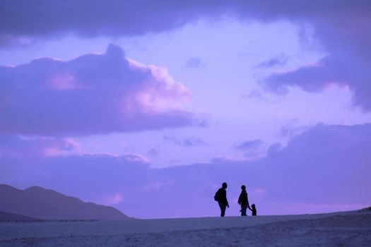 Silhouette of the family on their evening trip in the desert