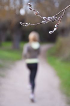 Young beautiful girl running in the springtime