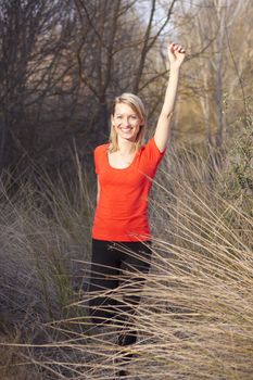 Beautiful young woman  streching in the clearing.