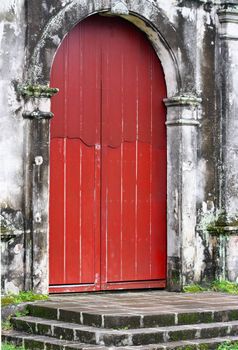 An old door of an abandoned catholic church