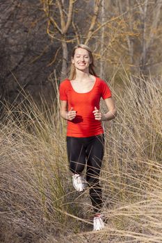 Young beautiful girl running in the autumn environment.