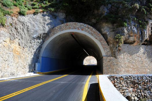 Travel photography: Mountain road passing through a tunnel in the island of 

Crete.