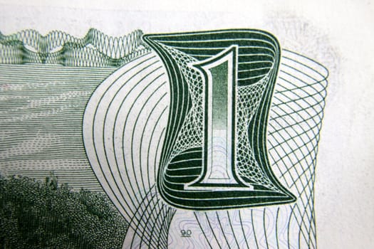 Close up of number one on canadian dollar bill