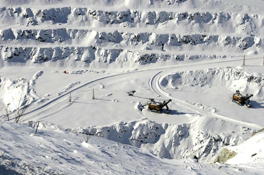 Loader in open mine shaft in winter