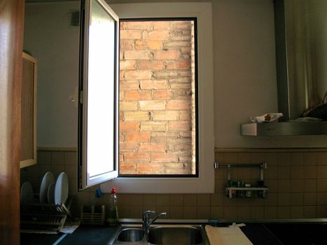 Apartment window that opens to a brick wall