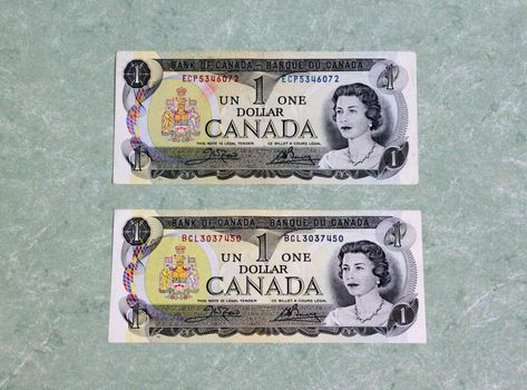 Pair of canadian dollar bills on marble background