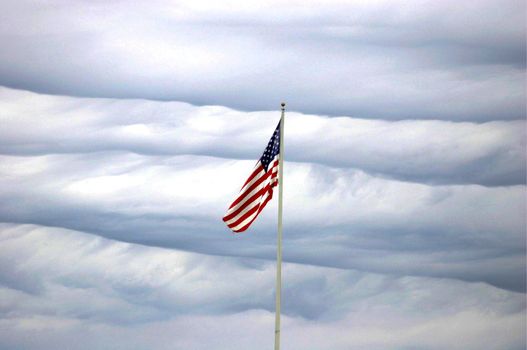 US flag on wavy cloud background