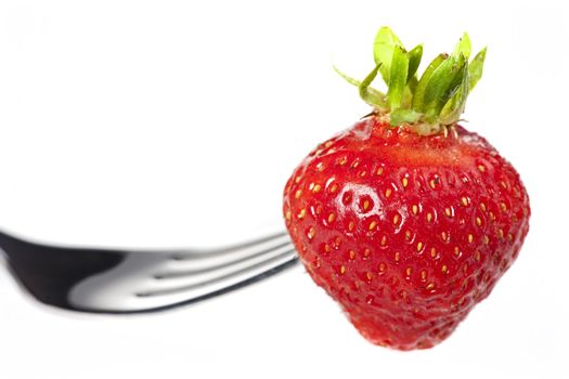 single strawberry on a fork isolated on white