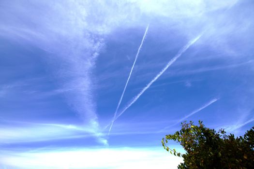 Airplane flumes crossing in the sky