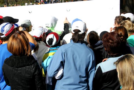 People in front of board in an outside event