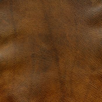 distressed brown leather background with some wrinkles - a top of old horse saddle