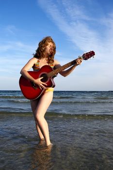 women, guitar and sea