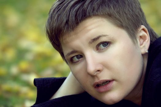 Young amused woman with a bob haircut closely