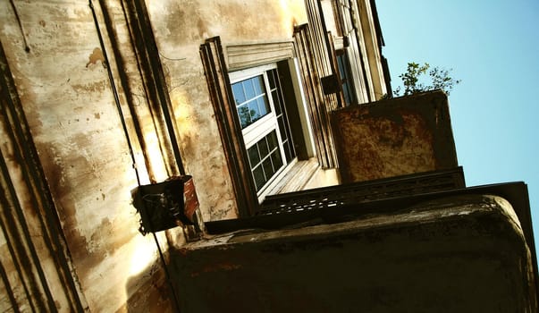 Burnt ancient building with balconies on the sky background