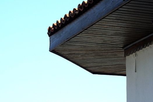 Wooden roof of an old house on the sky background