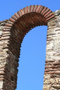 Ancient brickworked arc on the sky background