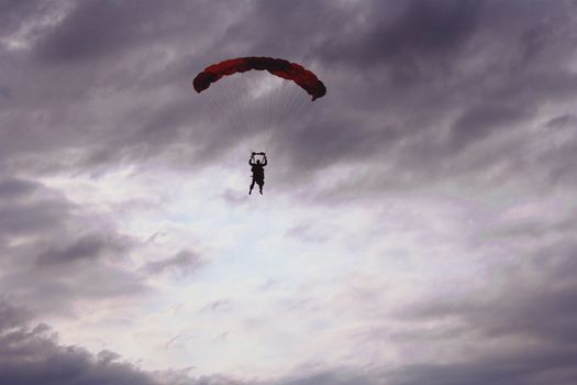 Parachuting in the gloomy cloudy sky