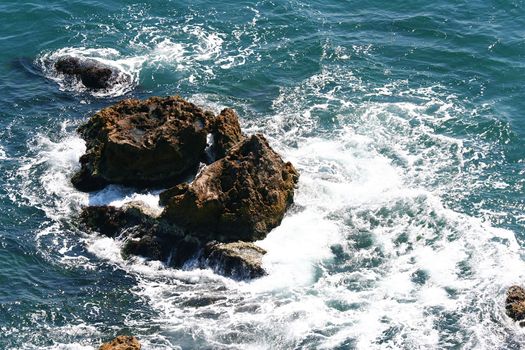 The waves crashing and foaming on the reefs in the sea