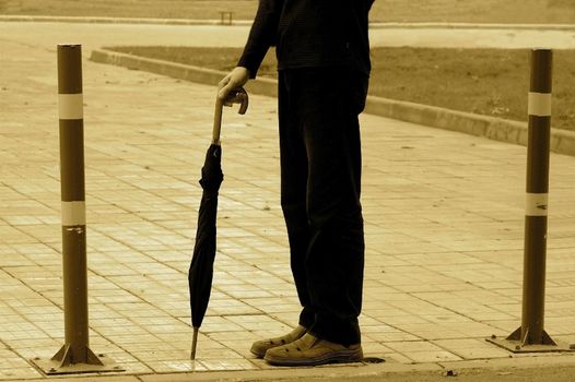 Abstract picture of a waiting person with umbrella