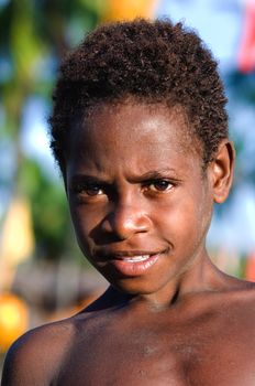 ASIA, INDONESIA, PAPUA (IRIAN JAYA), ASMAT PROVINCE - 19 JANUARY 2009: Children asmat a tribe. Children of a tribe of asmats in a deaf forest small village see off a boat. 19 january 2009