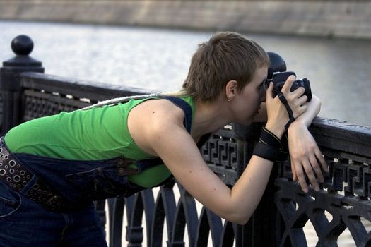 Young woman photographer making shots