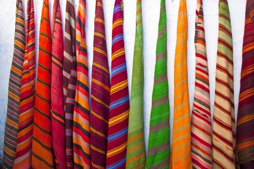 Colourful  carpets sold in maroccan souk.
