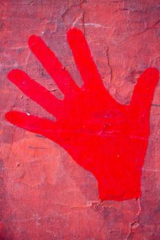 Red hand print on the  red wall.