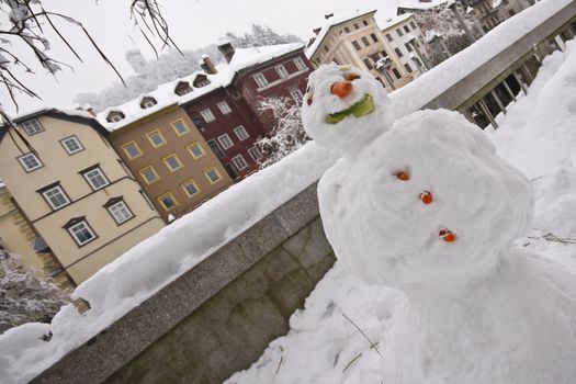 Kids made a snow man in the historical centre of Ljubljana
