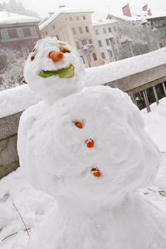 Kids made a snow man in the historical centre of Ljubljana