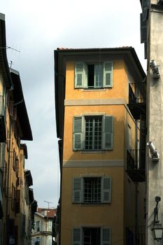 Old yellow building with the green shutters