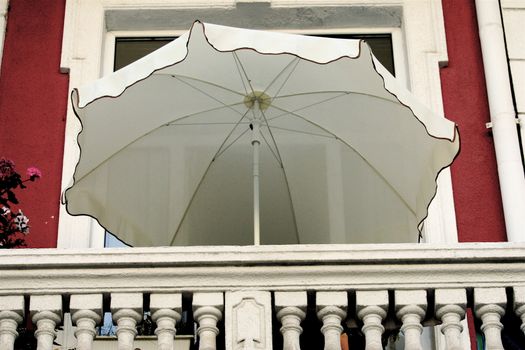 Umbrella staying on the balcony because of the hot weather
