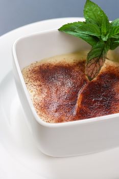 A selective focus, closeup image of a bowl of Tiramisu.
