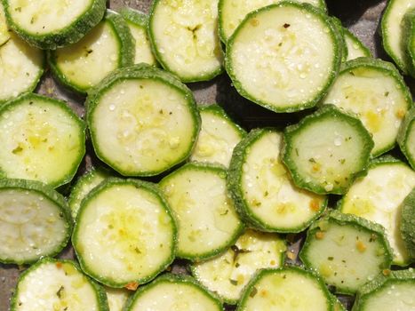 Green courgettes or zucchini vegetables useful as a background