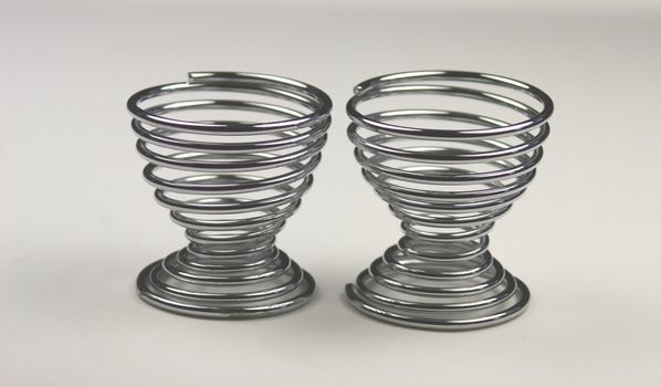 two spiral metal egg cups empty and waiting for an egg