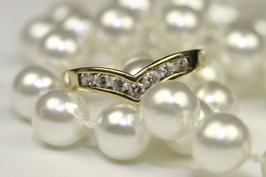 string of pearls with a wishbone diamond engagement ring