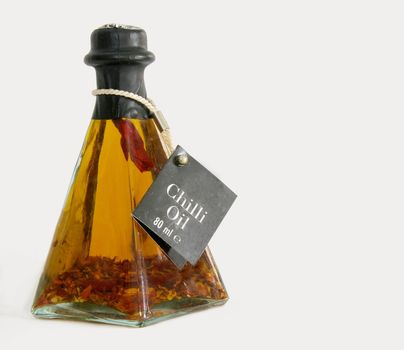 chilli oil in a pyramid shaped glass bottle