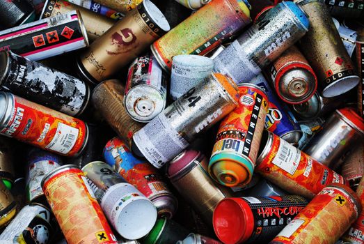 A pile of spray paint cans.