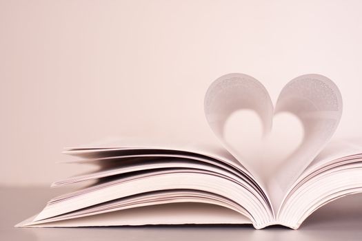 Pages of a book forming the shape of the heart.