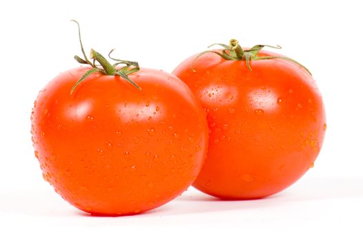 two fresh tomatos isolated on a white background