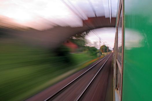 Two trains passing in opposite directions with motion blur
