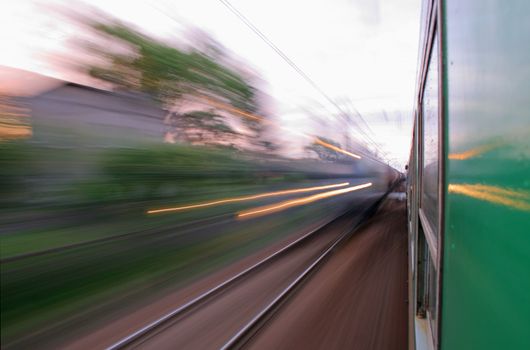Two trains passing in opposite directions with motion blur
