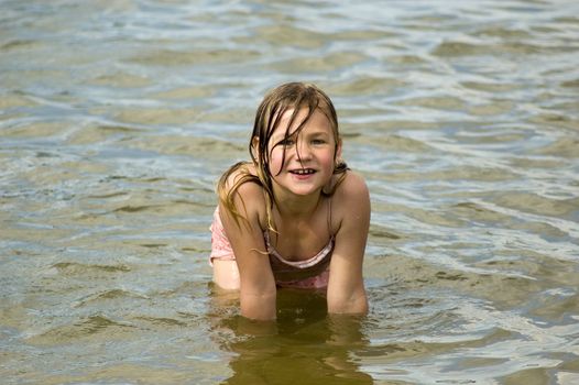 little girl is playing and having fun in the water